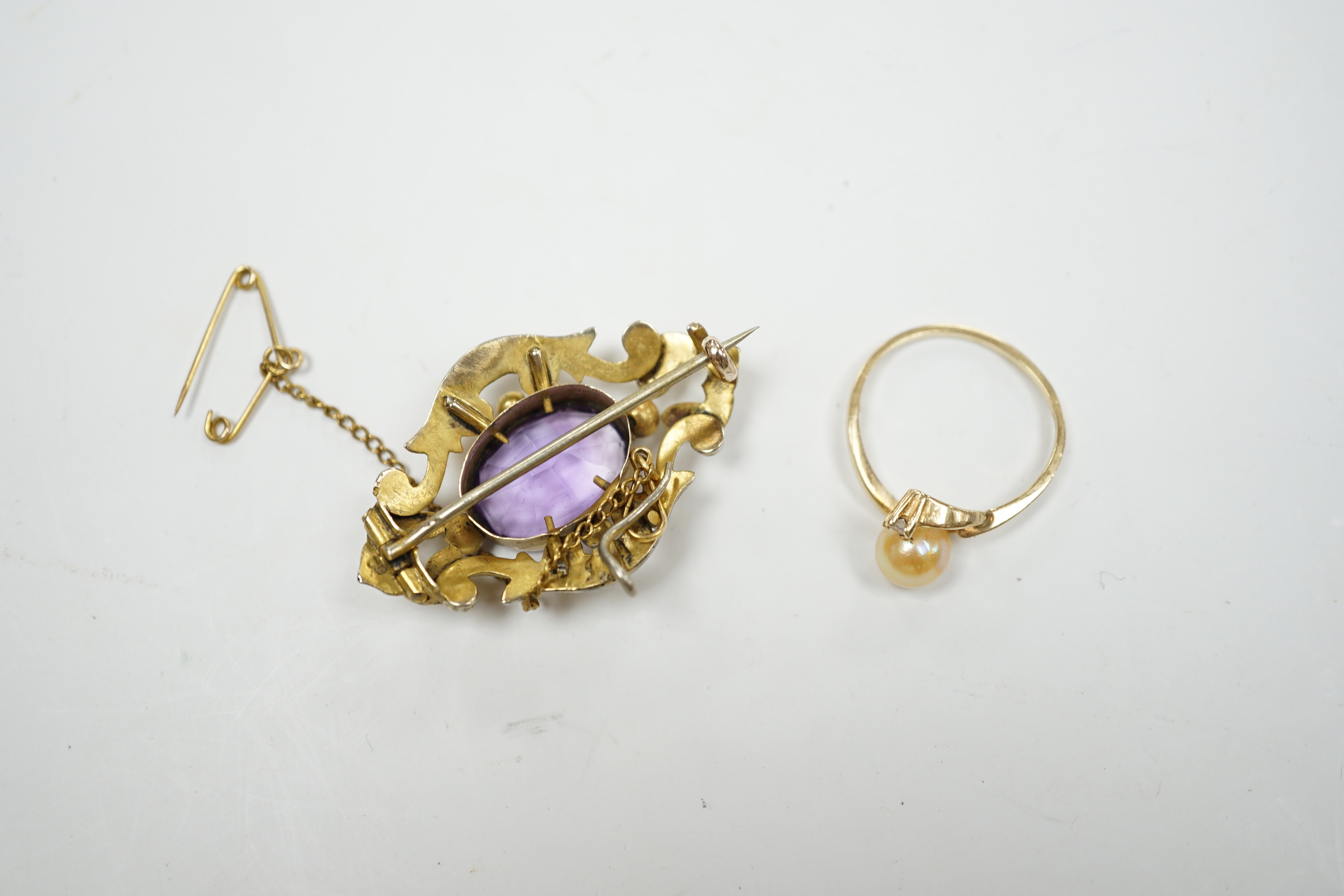 A late Victorian yellow metal mounted amethyst brooch, 38mm pendant and a 10k, cultured pearl and diamond set two stone ring.